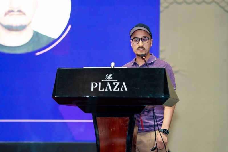 Puru Tuladhar speaking at a community tech event