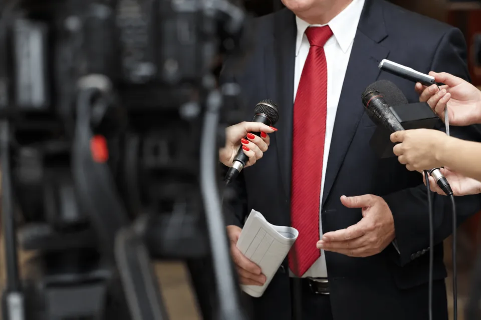 Media interviewing a speaker at an event